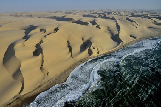 Aerial view, dunes in Namib desert, Atlantic Ocean, waves breaking on Namibian coast south of Sandwich Harbour, Namib-Naukluft National Park, Namibia, Africa