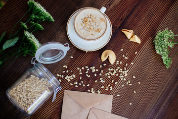 Cappuccino with nuts on the table.
