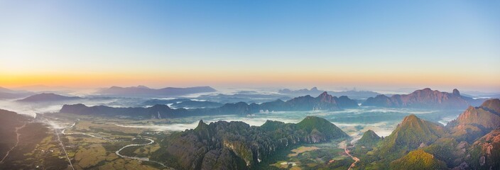 Panorama of karst mountains with mist at sunrise, Vang Vieng, Vientiane Province, Laos, Asia