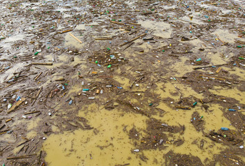 lake water pollution with plastic bags and dirt