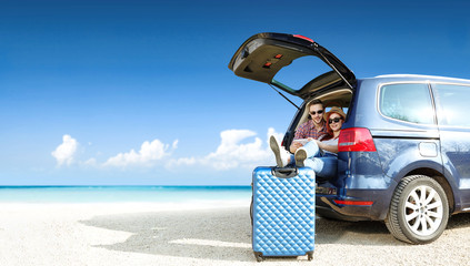 Summer trip on beach. Big blue car with two people. Free space for your text.  © magdal3na