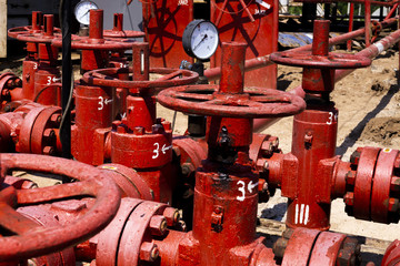 Oil and gas processing plant with pipe line valves. Oil pipeline valves in the oil and gas industry. Valve plug an oil pipeline in the field on a sunny summer day