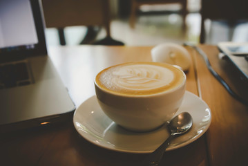 coffee cup on a wood table in the morning