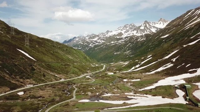 drone flying on swiss alps with some snow