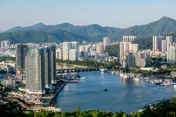 skyscrapers of the city against the backdrop of the mountains. China. Hainan.