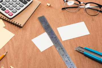 Knife with ruler and paper on wood table
