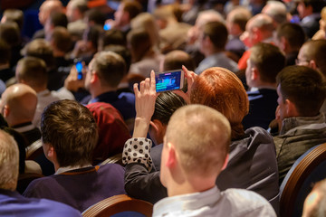 People attend business conference in the congress hall