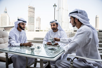 arabic business men spending time in Dubai - obrazy, fototapety, plakaty