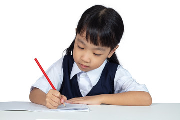 Asian Chinese little girl wearing school uniform studying