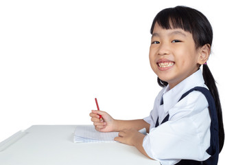 Asian Chinese little girl wearing school uniform studying