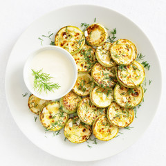 fried courgettes with yougurt dip sprinkled with dill and garlic