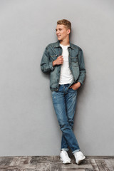 Full length portrait of a smiling casual teenage boy