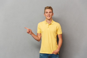 Portrait of a smiling casual teenage boy pointing © Drobot Dean