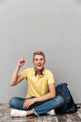 Portrait of a smiling casual teenage boy with backpack