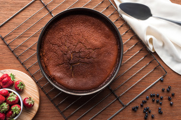 top view of delicious homemade brownie and fresh berries on wooden table