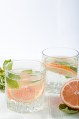 Fototapeta na wymiar Basil grapefruit water. Drink infused water cocktail. Healthy lifestyle concept. Copy space