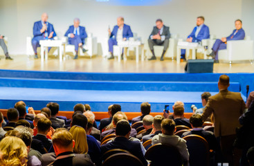 People attend business conference in the congress hall