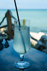 Lemonade glass on a table by the sea in summer