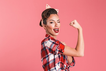 Gorgeous strong young pin-up woman showing biceps.