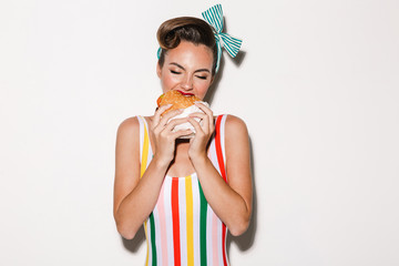 Pretty pin up woman eating burger.