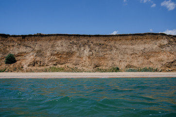 Fototapeta na wymiar View of a deserted summer beach from the sea.