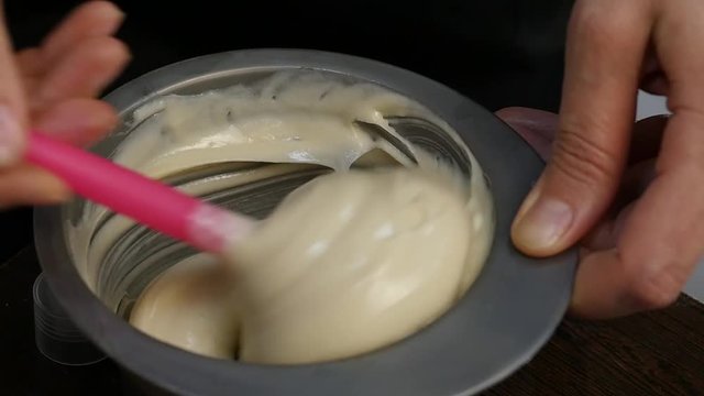 process of mixing of components for reception without an aldehyde paint in a beauty salon. slow motion
