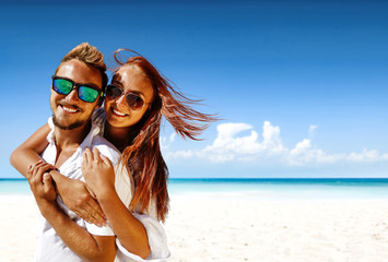 Summer trip on beach. Two lovers and sea landscape with blue sky. Free space for your text. 