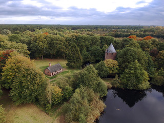 Obraz premium Aerial picture of forest with old tower mill in Belgium
