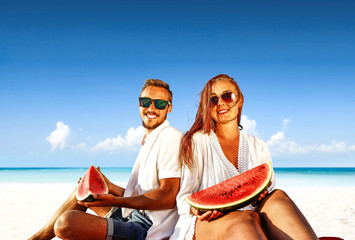 Summer trip on beach. Two lovers and sea landscape with blue sky. Free space for your text. 