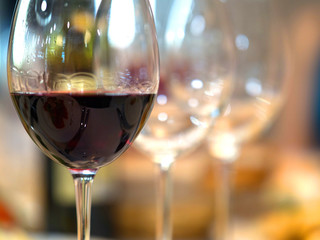 Red Wine in front of beautiful blurred wedding background.