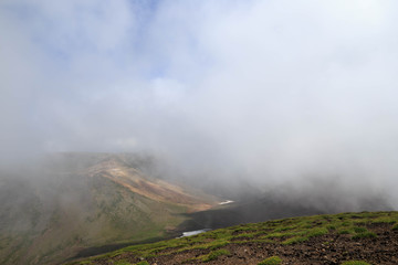 Clouds over valley on summit of Mt. Asahi in Hokkaido, Japan