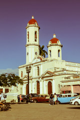 Vintage cars parked in the Jose Marti Park, in front of the Purisima Concepcion Cathedral. Cienfuegos, Cuba.