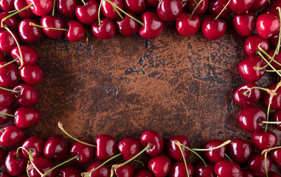 Sweet organic cherries on old copper table.