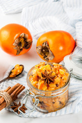Traditional indian food recipes, Persimmon fruit Chutney with cinnamon and anise stars, white marble background copy space