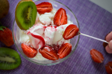 spoon strawberries over cream sundae