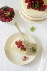 Summer home biscuit cake with curd cream, decorated with fresh berries of strawberries, raspberries and currants.