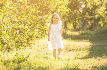 Little girl in white dress looking to the side