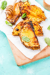 Grilled pineapple slices with mint, Honey and lime sauce, on light blue background copy space