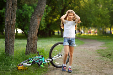 The girl was injured while riding a bike in the summer.
