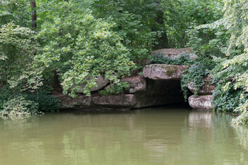 The lake with a stone entrance to the tunnel, the grotto.
