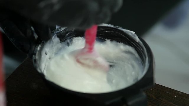 process of mixing of components for reception without an aldehyde paint in a beauty salon. slow motion