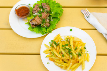 Fried pieces of meat and french fries.