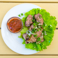 Shish kebab on a plate. Pieces of grilled meat.