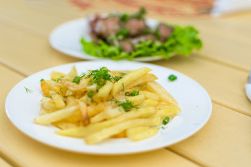 French fries on a plate in a cafe.