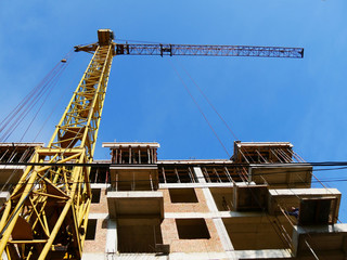 Construction crane near building. Construction site.