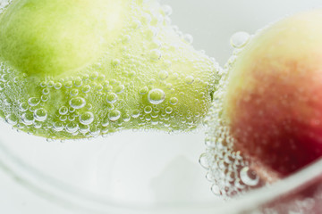 Fresh fruits in water wiht air bubbles.