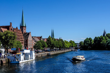 Excursion boat on the river Trave  on a beautiful summer day