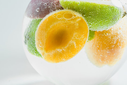 Fresh fruits in water wiht air bubbles.