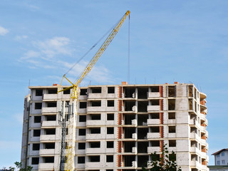 Fototapeta premium Building under construction. Construction site. Crane near building.