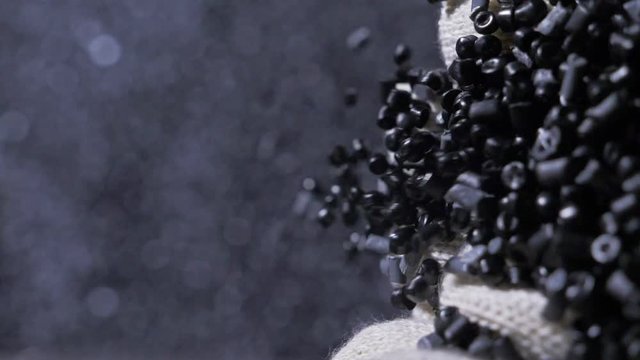 Plastic black gray granulated crumb. Manufacture of plastic water pipes of the factory. Process of making plastic tubes on the machine tool with the use of water and air pressure.